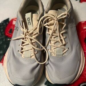 On Running women’s Cream/orange and Gray/purple Sneakers